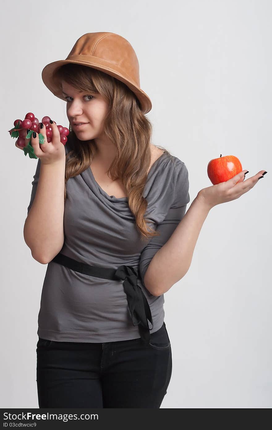 Girl With Grapes And Apples In The Hands Of