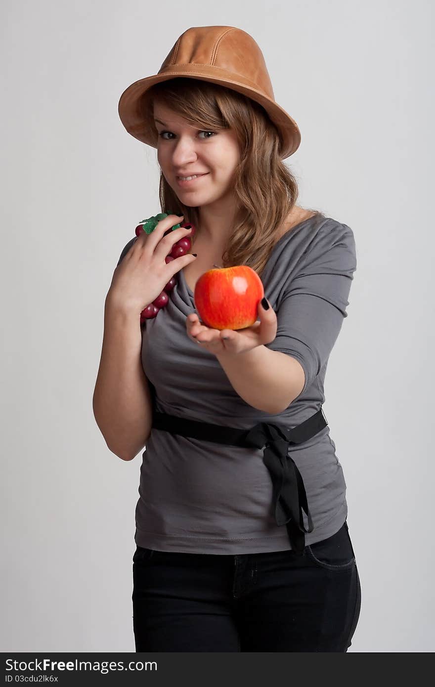 Girl with grapes and apples in the hands of