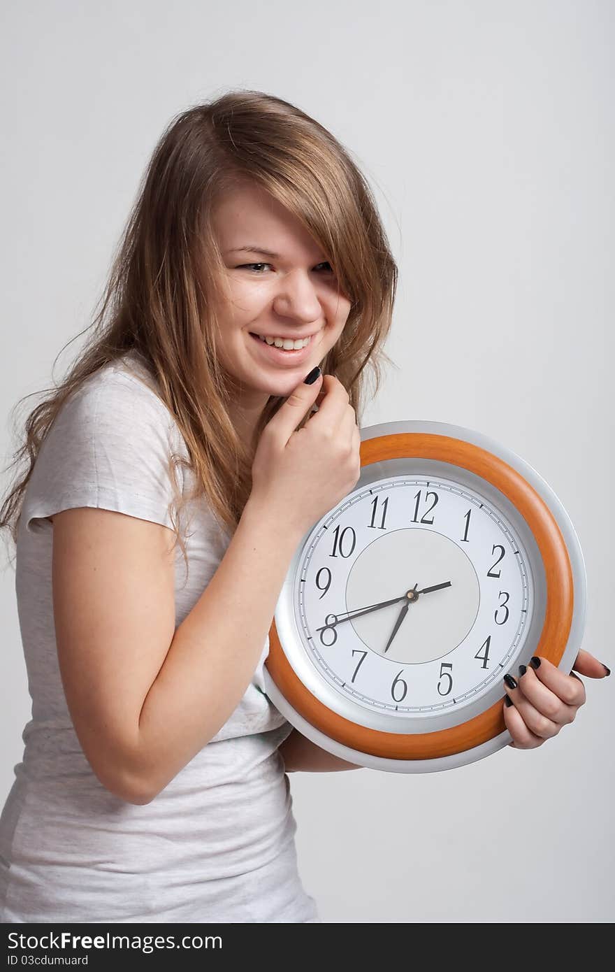 Beautiful girl with a big clock