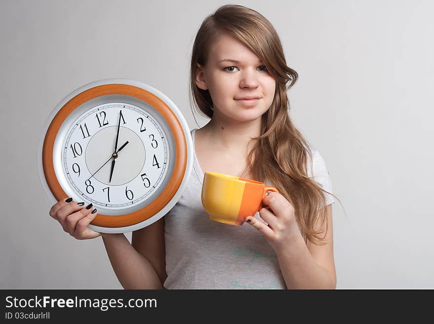 Portrait of a girl with a cup and a clock