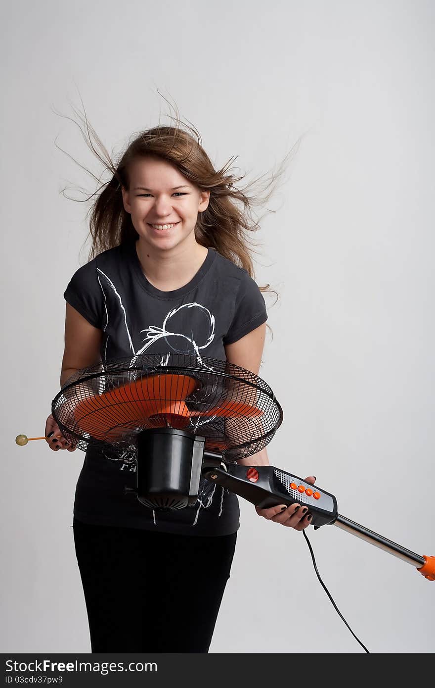 Girl with a fan on a light background. Girl with a fan on a light background