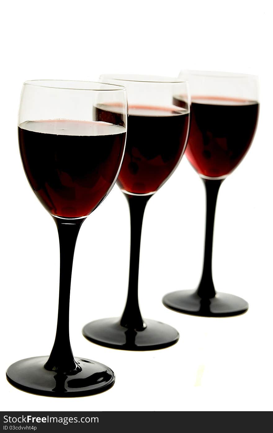 Red wine in glass glasses on the white isolated background