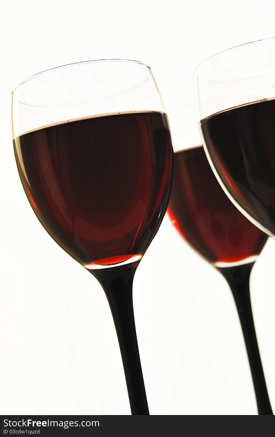 Red wine in glass glasses on the white isolated background