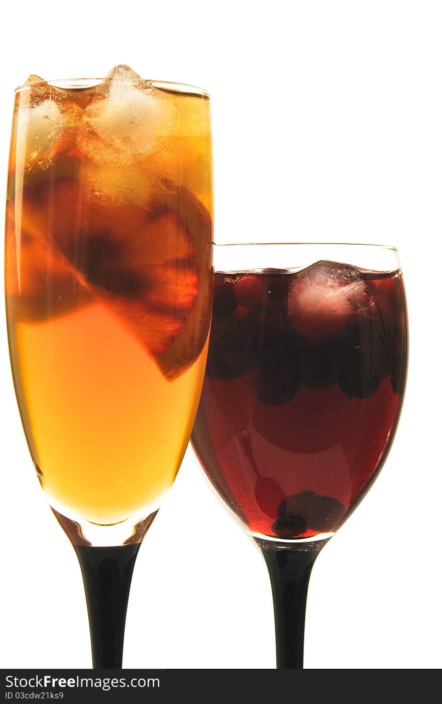 Fruit cocktail in glass glasses on the white isolated background