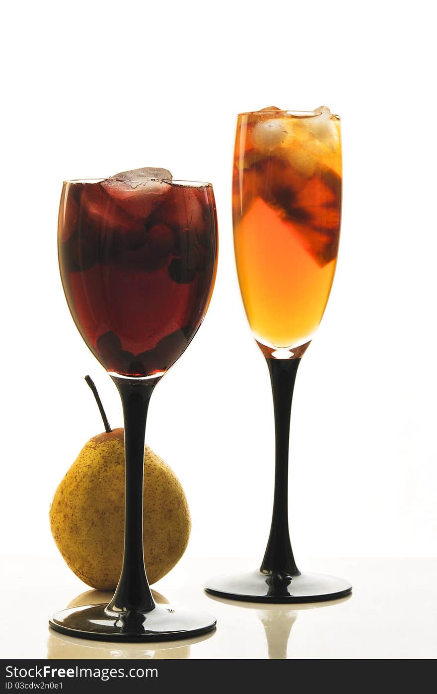 Fruit cocktail in glass glasses on the white isolated background