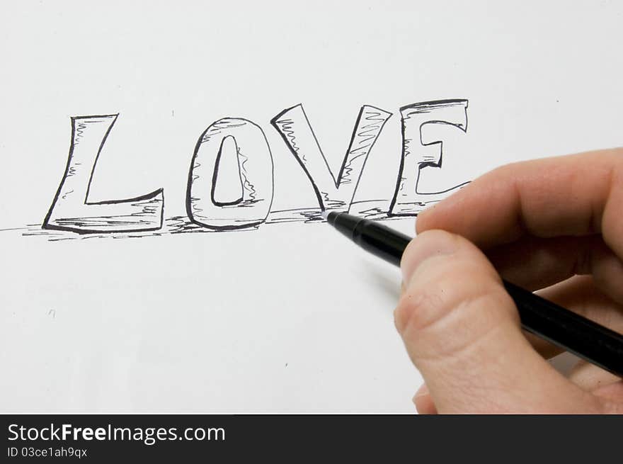 Artist writing LOVE on paper