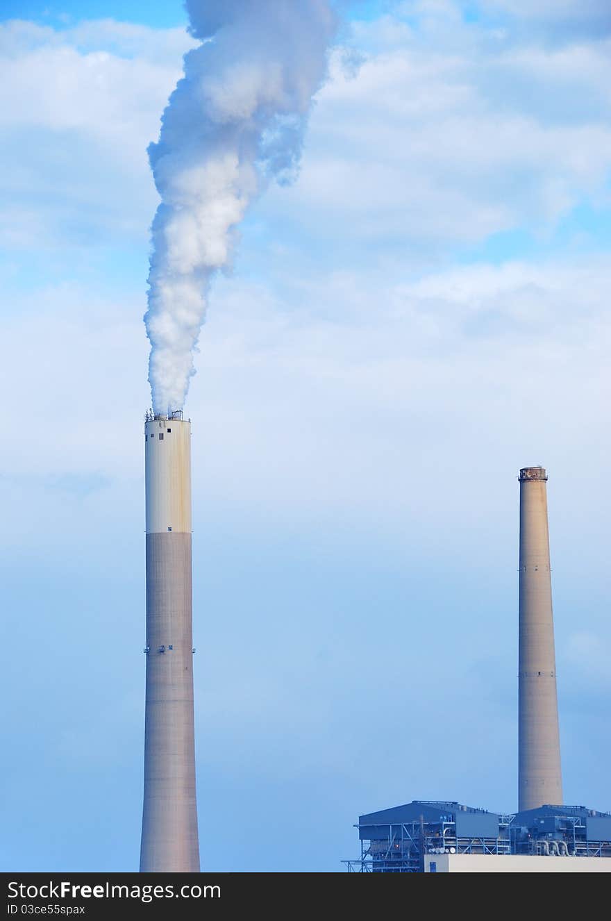 Smokestacks of power station on sky background