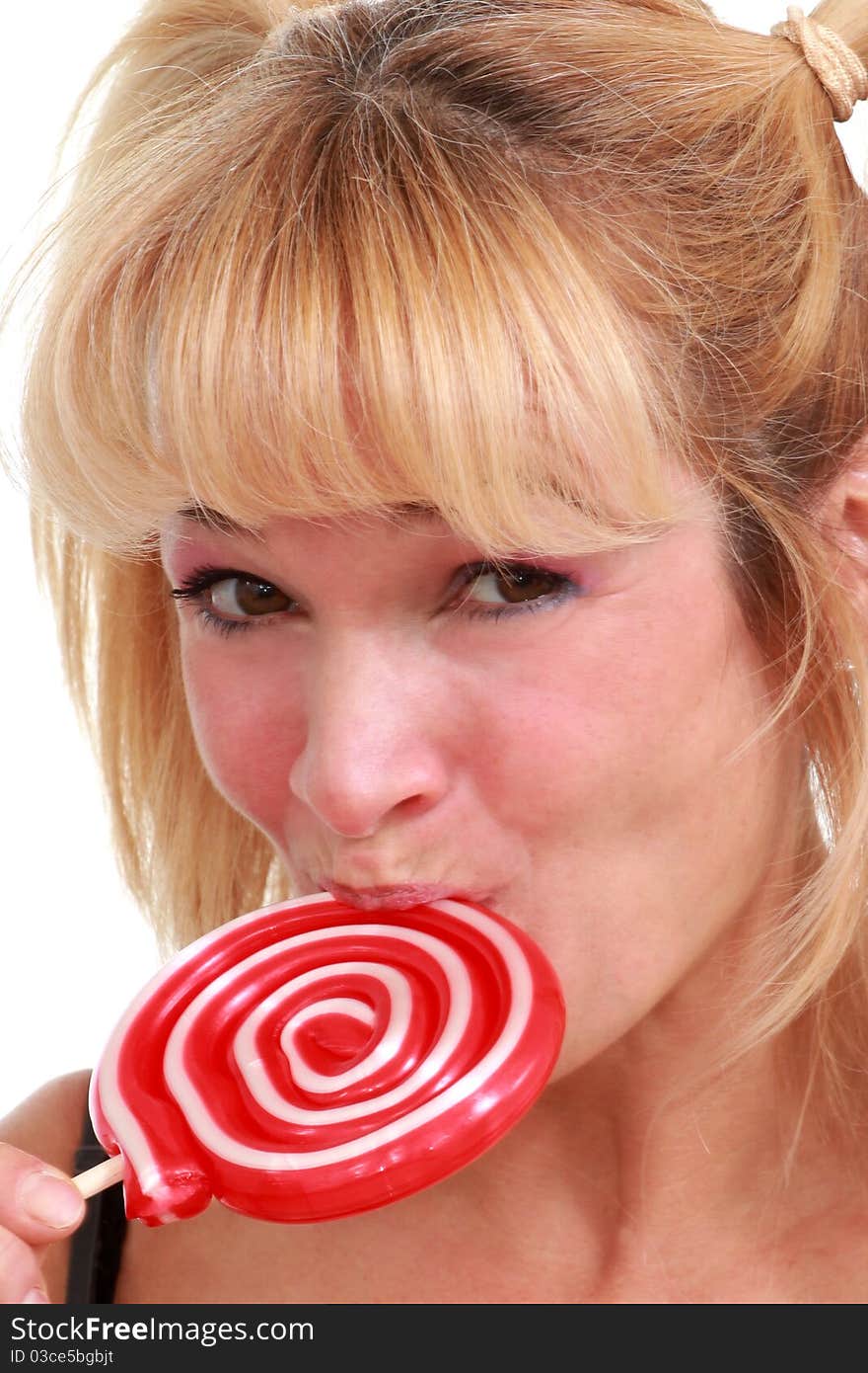 Middle aged woman enjoying a lollipop. Middle aged woman enjoying a lollipop