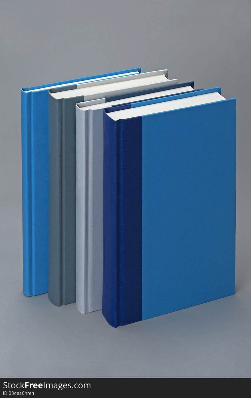 Four Plain books on a grey background for design. Four Plain books on a grey background for design