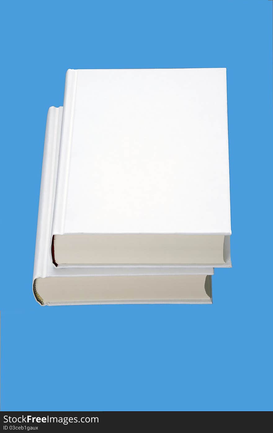 Two white books isolated on blue background. Two white books isolated on blue background