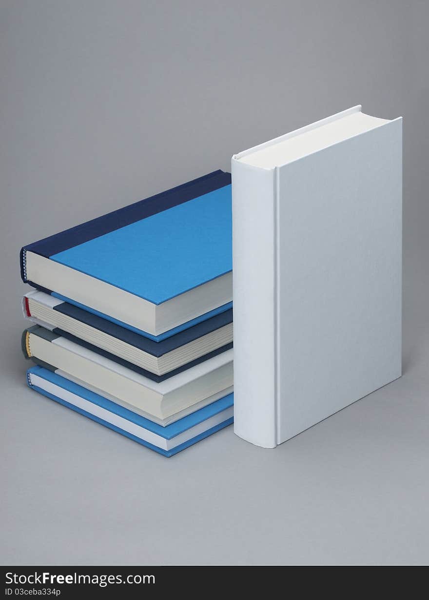 White, plain standing book with four others