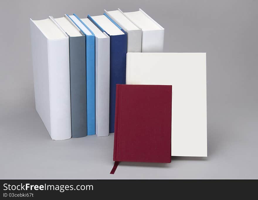 Plain books, white, blue and red