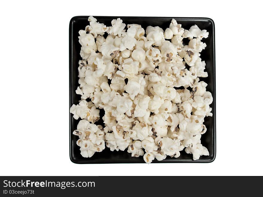 Picture of popcorn on a black plate. Picture of popcorn on a black plate