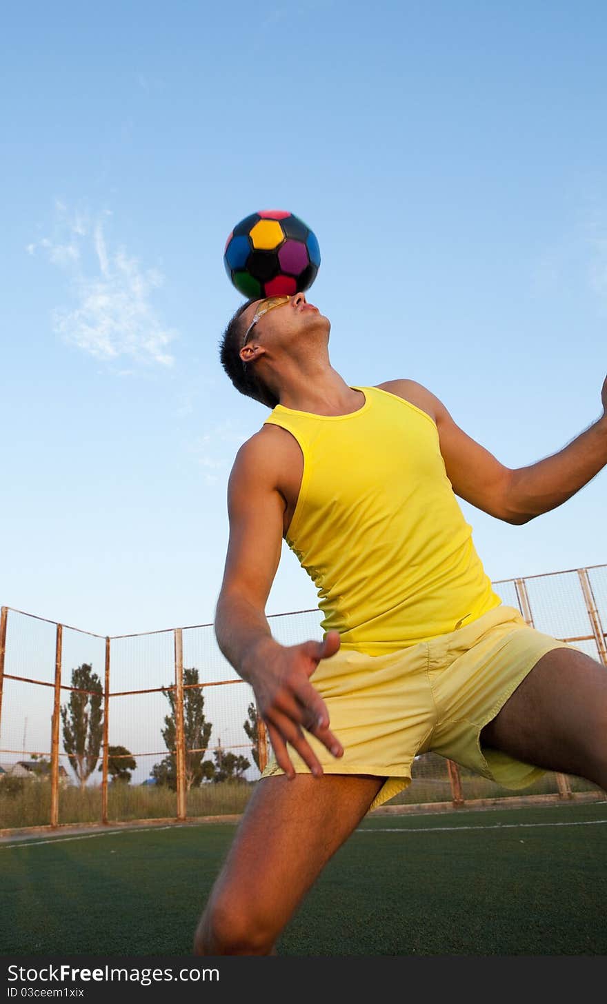 Football player shooting a ball with his head