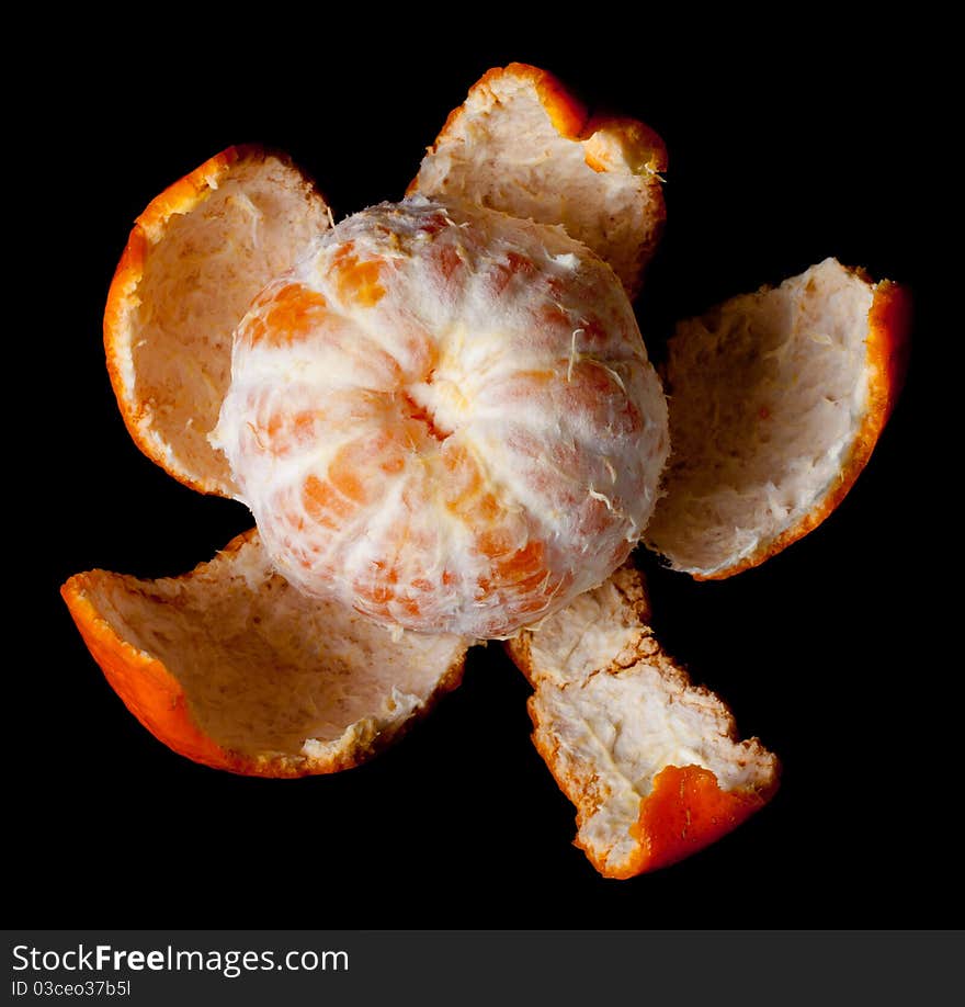 Single peeled mandarin on black background