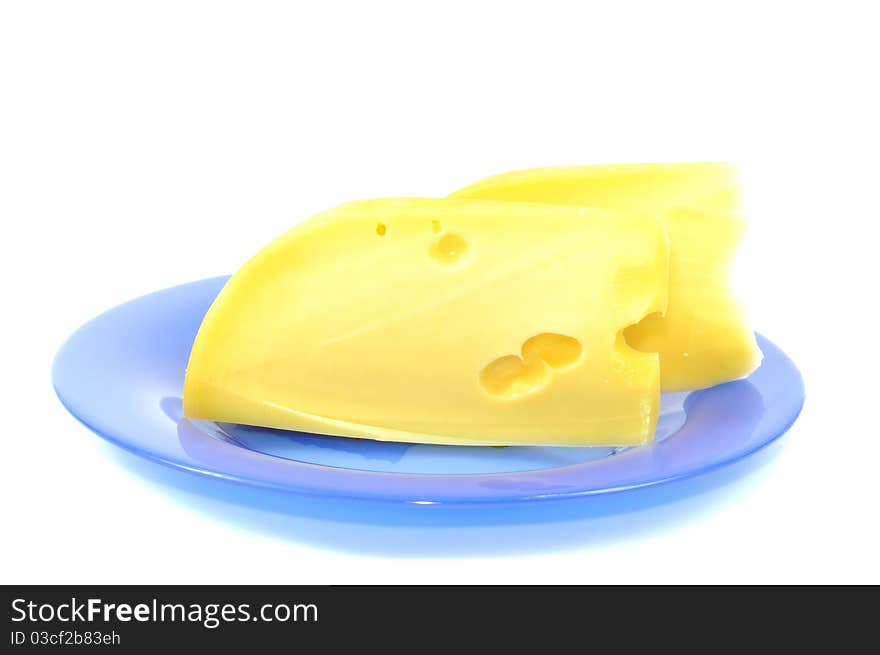 Fresh yellow cheese on blue plate, isolated on white