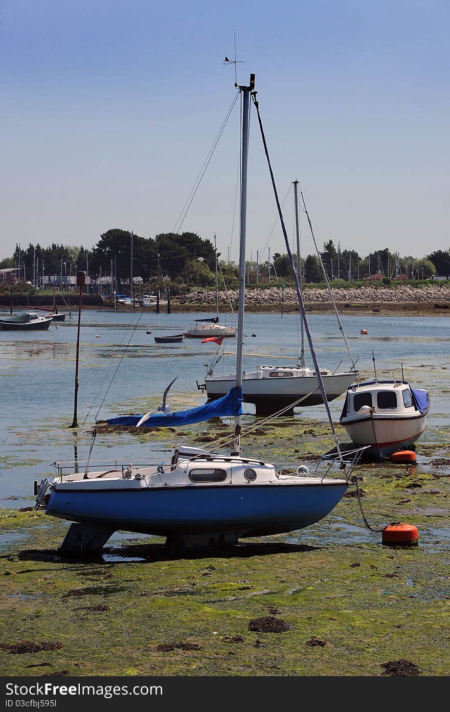 Yachts on the mud at low tide.