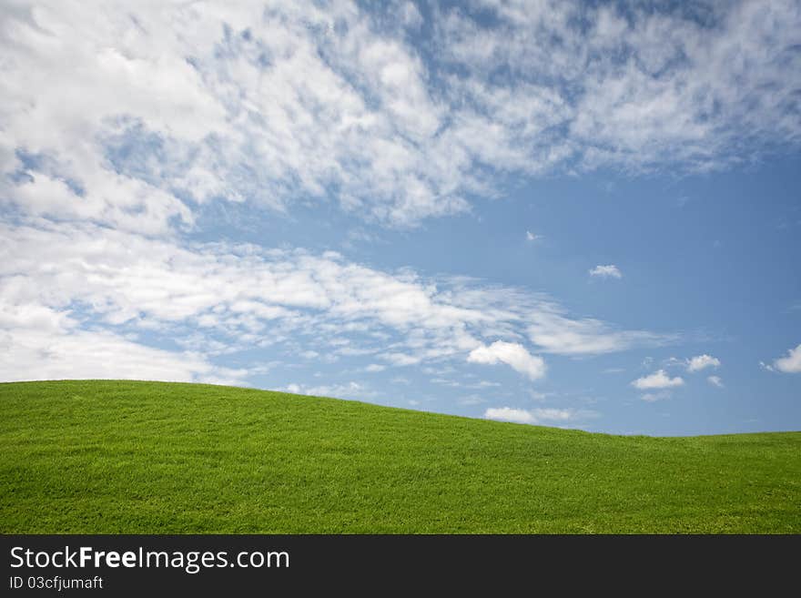 Panoramic view of nice green hill on blue sky background