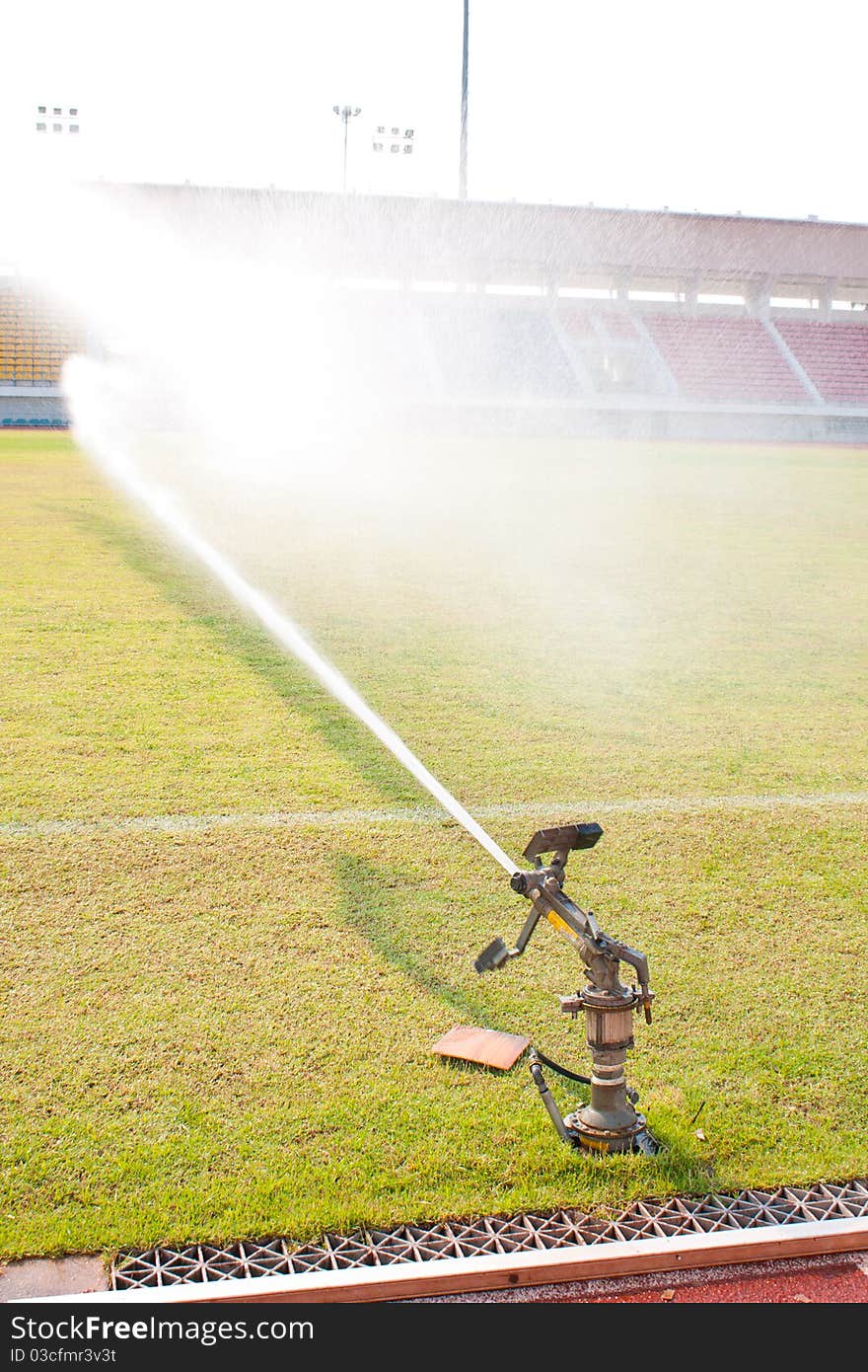 Nozzles are watering the field. care watering soccer fields.