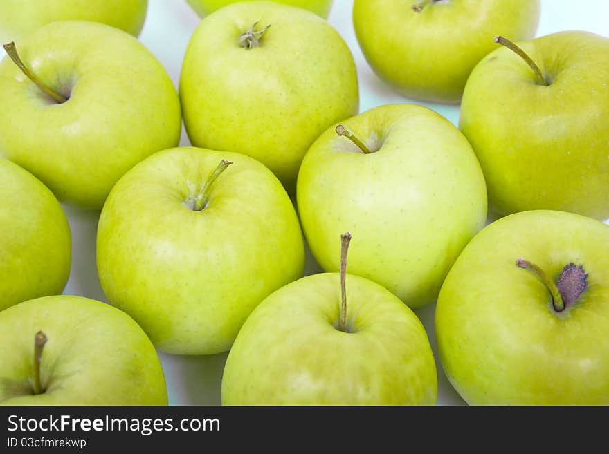 Green and yellow apples on a white background