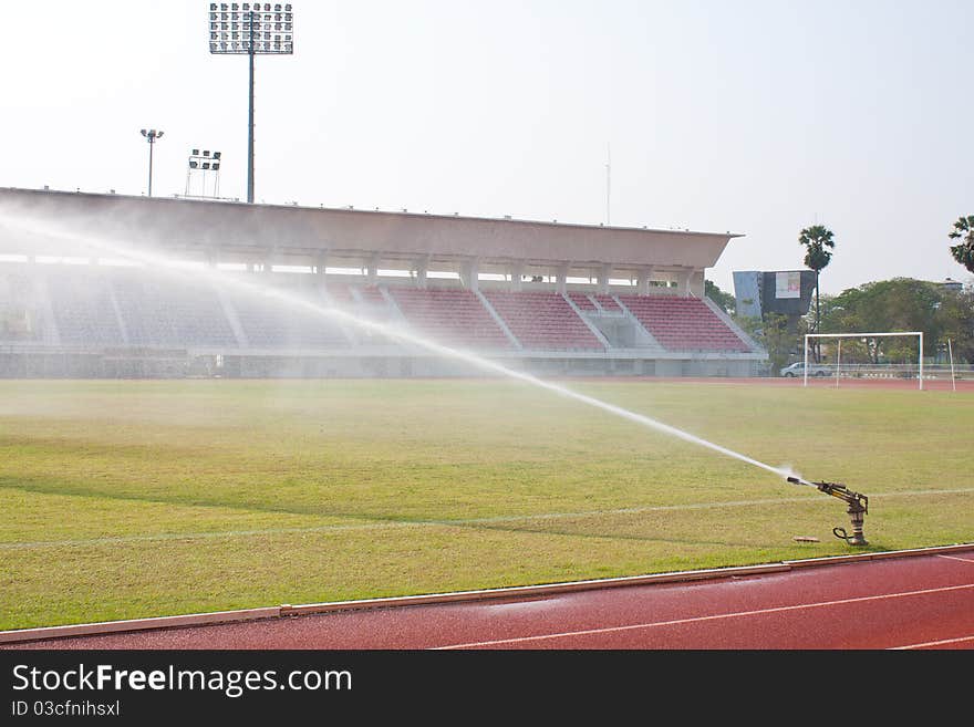 Nozzles are watering the field. care watering soccer fields.