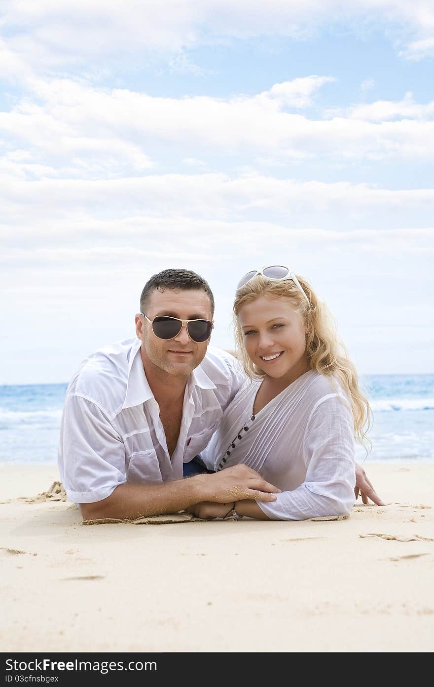 Portrait of young nice couple having good time on the beach. Portrait of young nice couple having good time on the beach