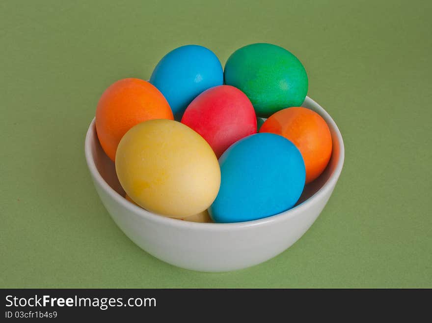 Easter eggs in ceramic bowl isolated on white background