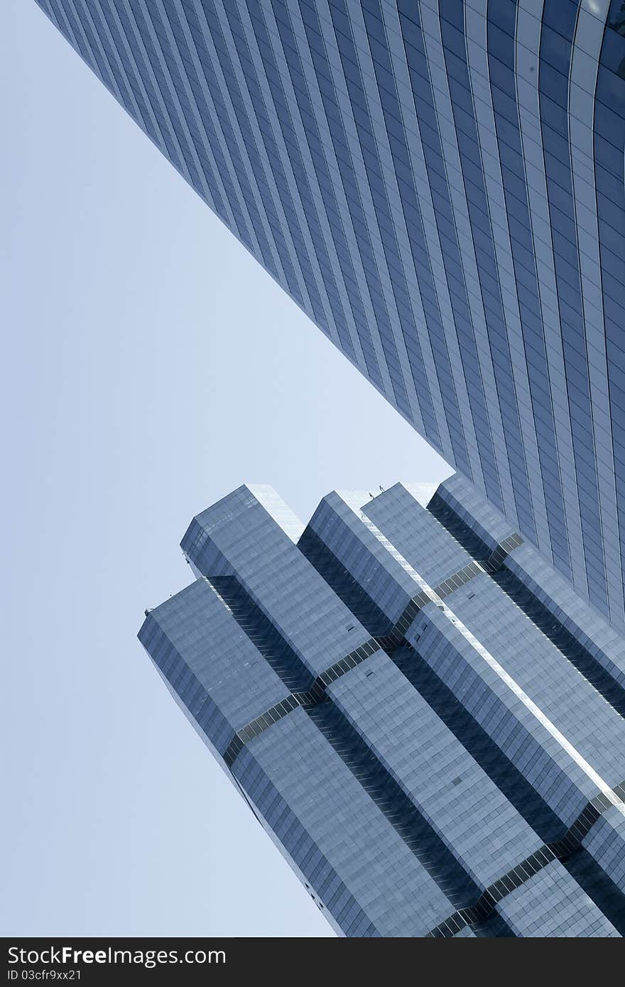 View of modern blue colored building on blue sky back. View of modern blue colored building on blue sky back