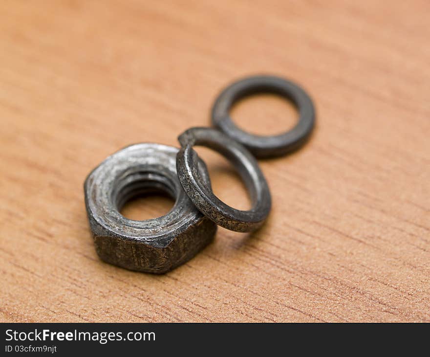 Nut and washer on a wooden table