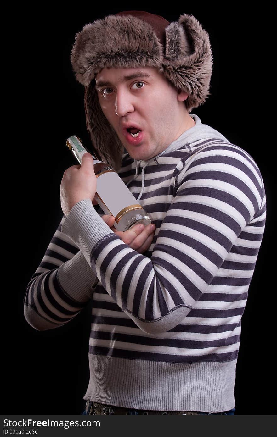 Man in a striped sweater with a bottle