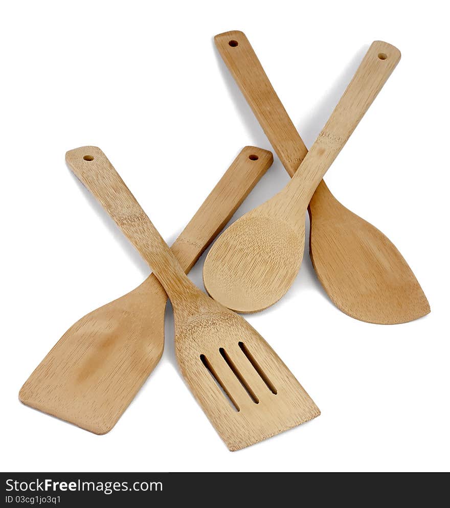 Kitchen accessories (spatulas and a spoon) from a bamboo on a white background. Kitchen accessories (spatulas and a spoon) from a bamboo on a white background.