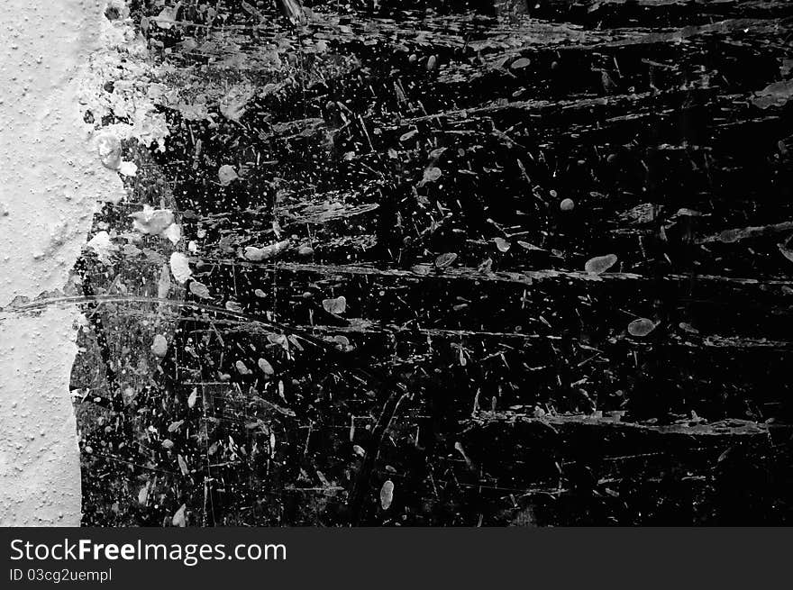 A dark concrete wall with paint splashes as a background. A dark concrete wall with paint splashes as a background