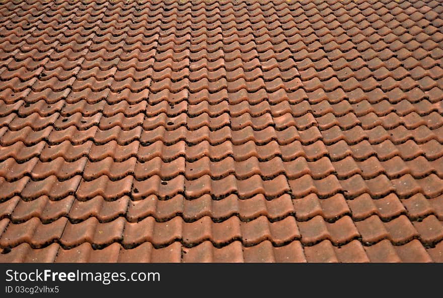 Roof of a house covered with old red tiling