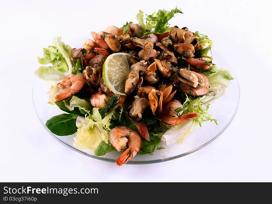 A salad with seafood on a glass plate