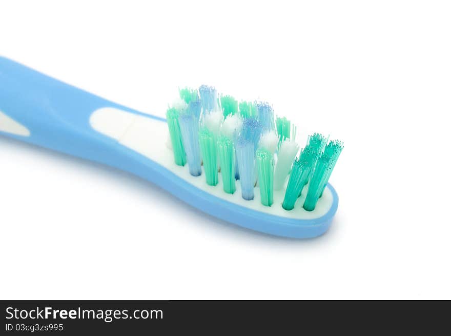 A close-up of an electric toothbrush on a white background. A close-up of an electric toothbrush on a white background