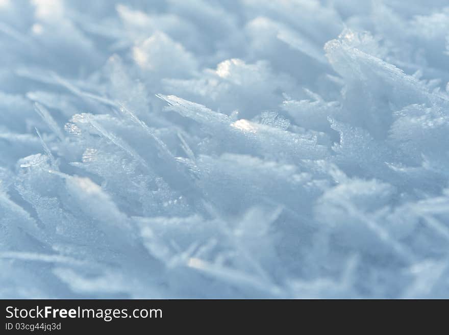 Thin crust of ice over snow, hoarfrost. Texture or background. Thin crust of ice over snow, hoarfrost. Texture or background.