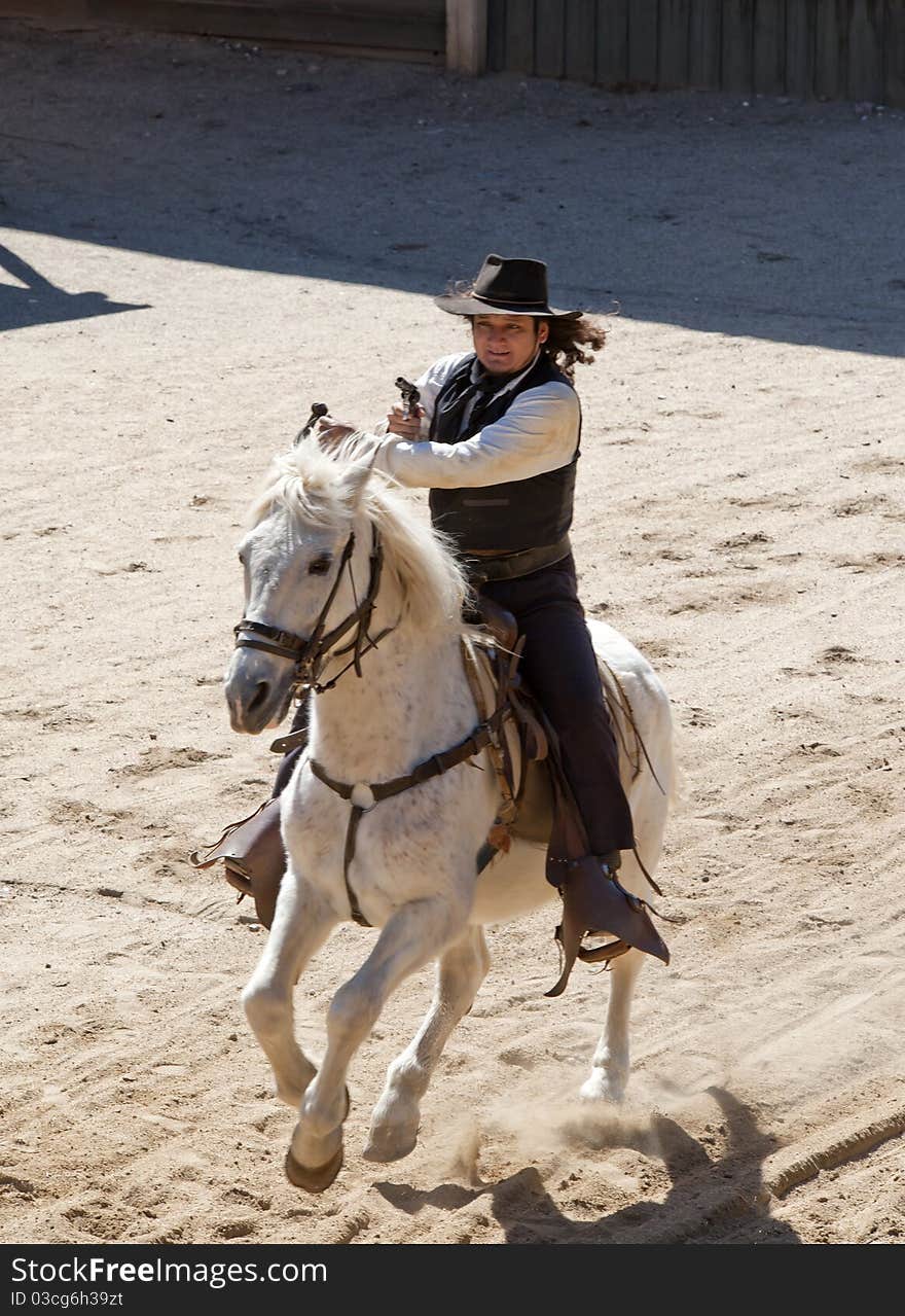 Deputy Sheriff shooting his pistol on horseback at Mini Hollywood, Almeria, Andalusia, Spain