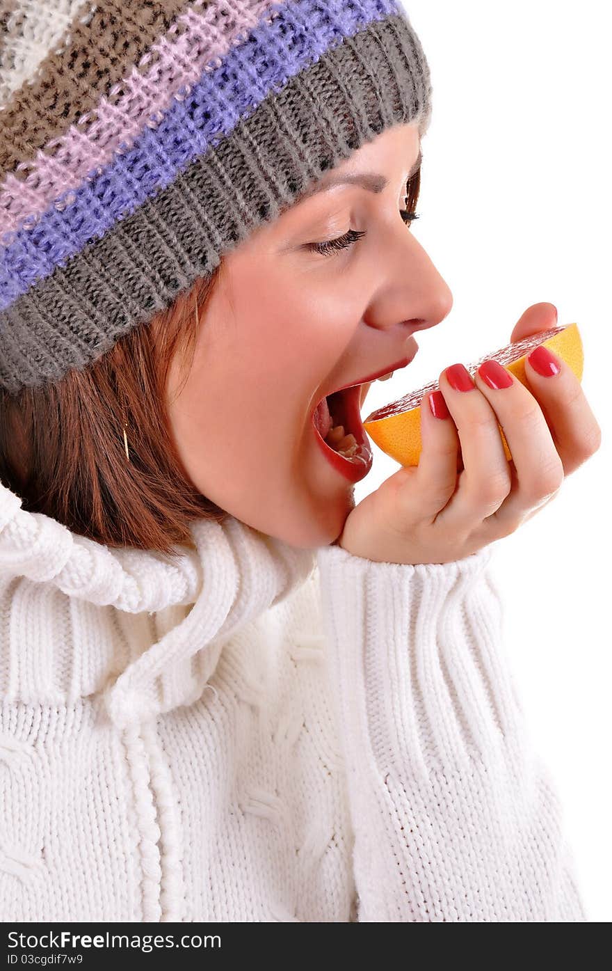 Young woman eating grapefruit - isolated