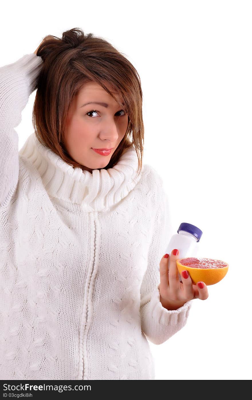 Woman's hands with orange and tablets