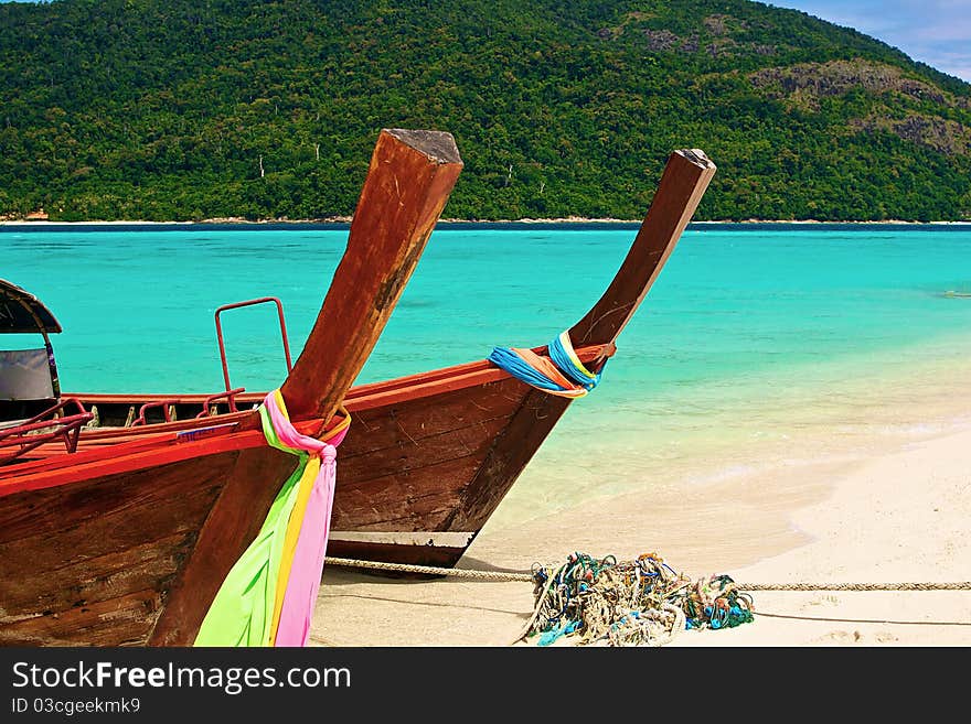 Paradise island and two boats in the green ocean