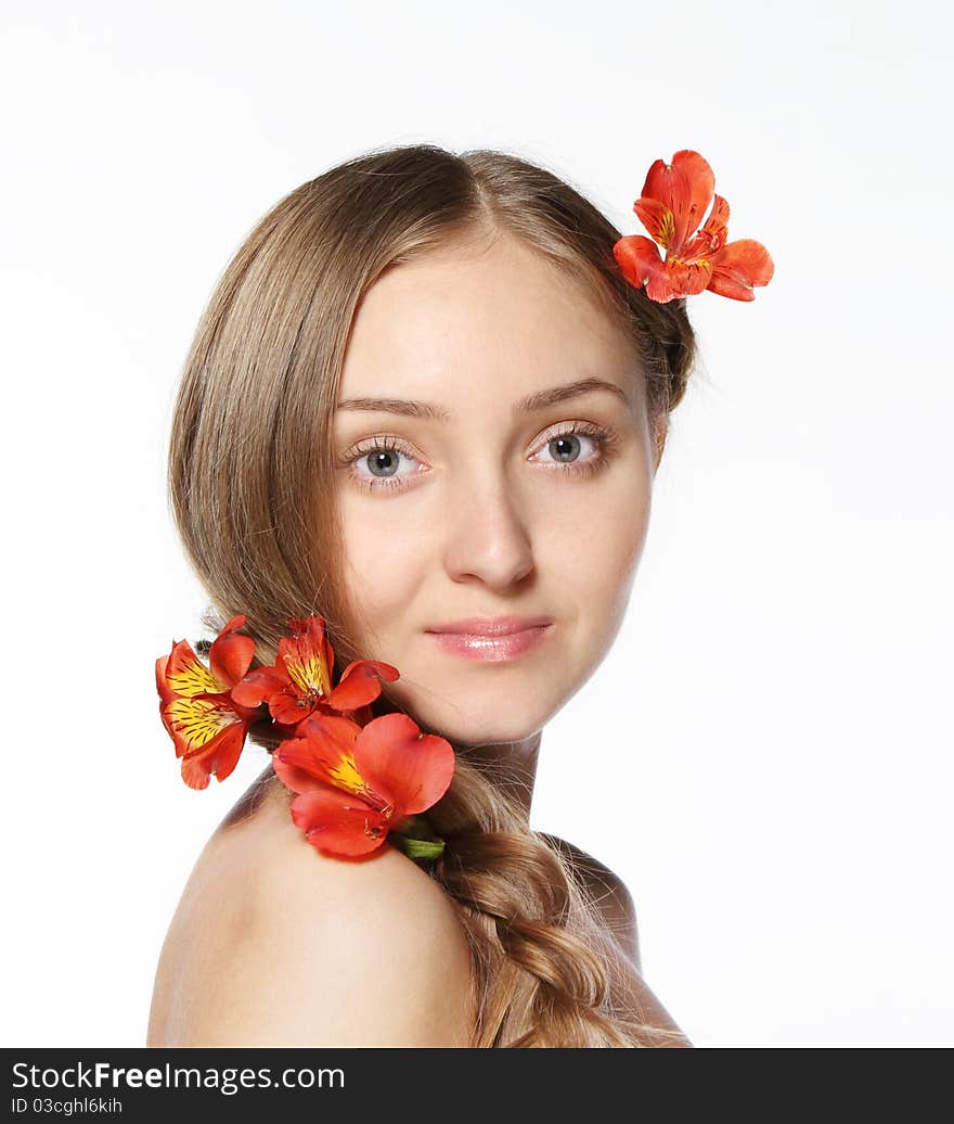 Portrait of the beauty young blond girl with lily in her hair