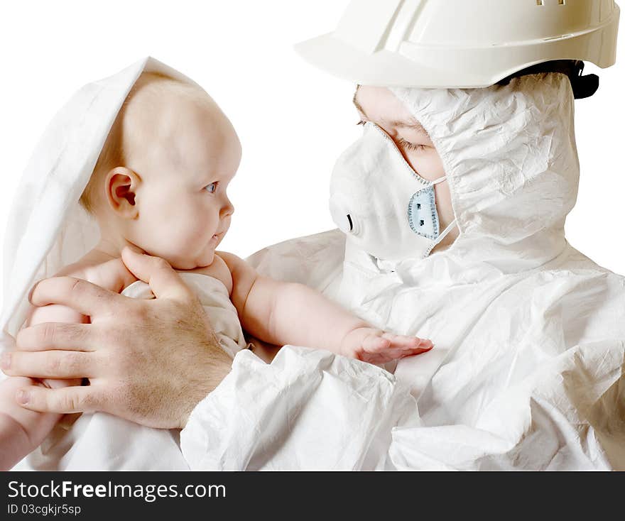 The man in protective clothes and a respirator holds the baby on hands. The man in protective clothes and a respirator holds the baby on hands