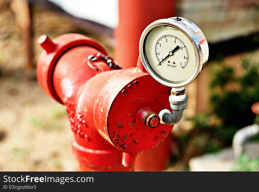 Red fire hydrant on a sidewalk With Zero pressure meter