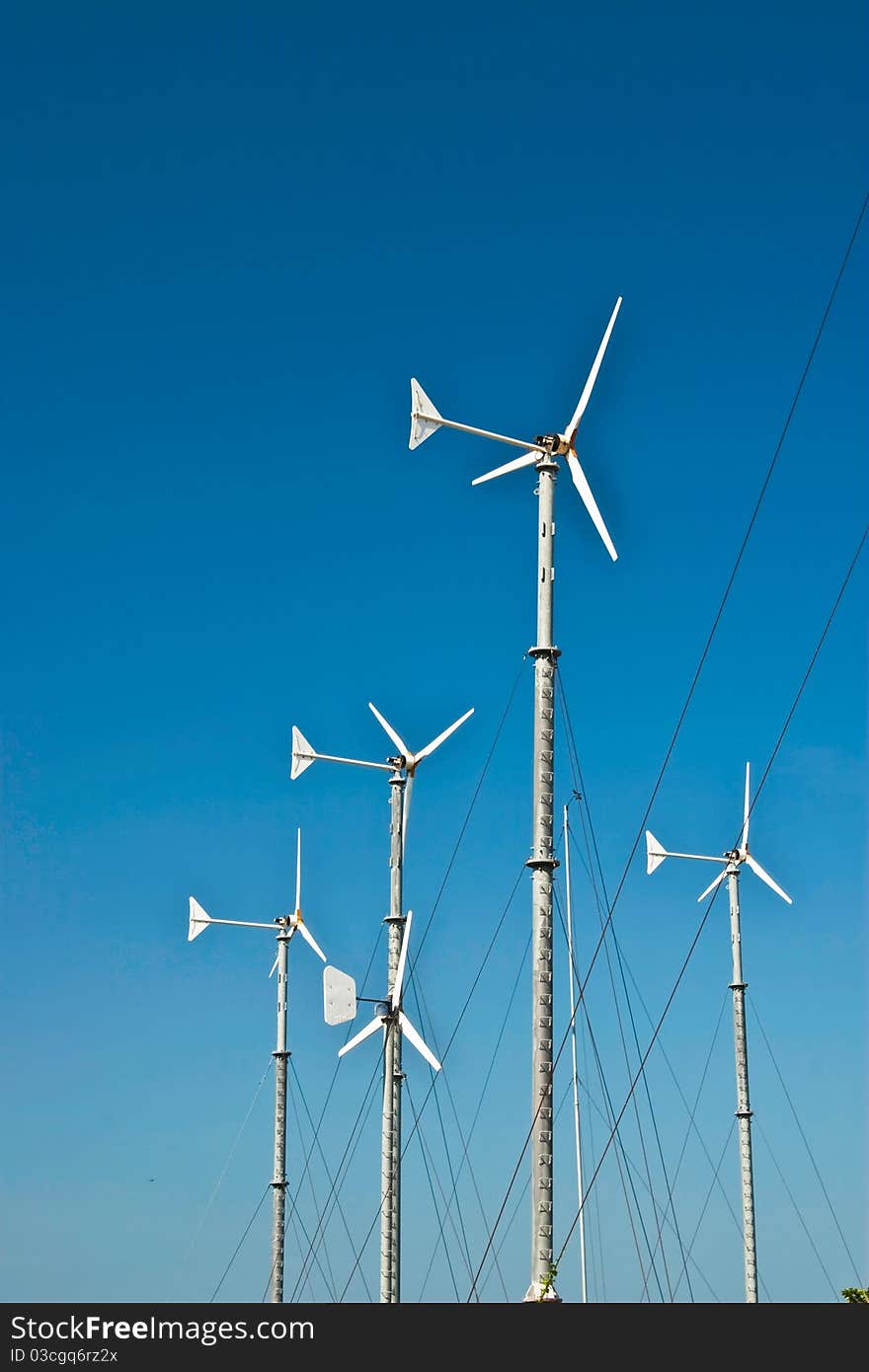 Turbine wind mills on blue sky background