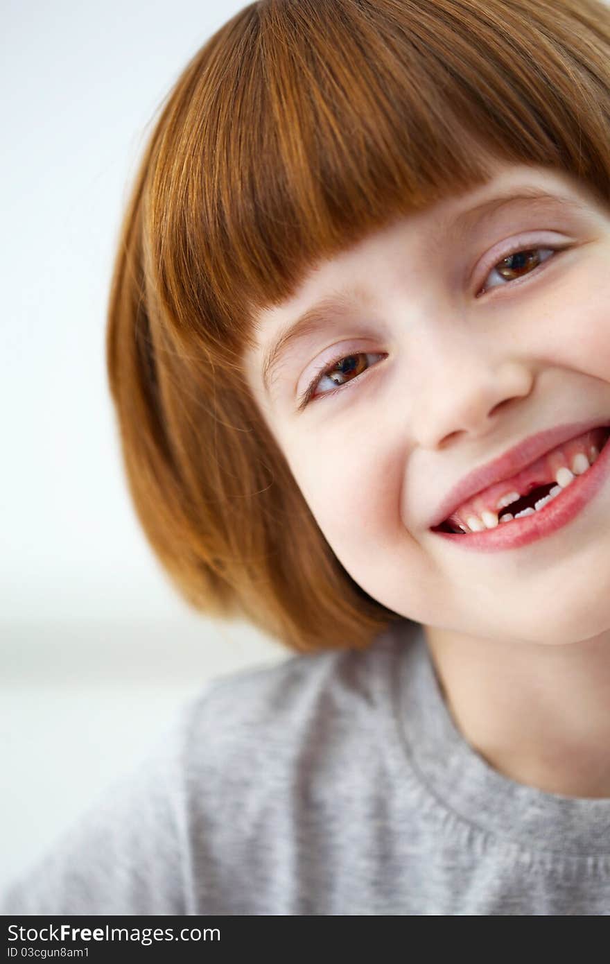 Closeup portrait of a cute smiling girl missing front teeth