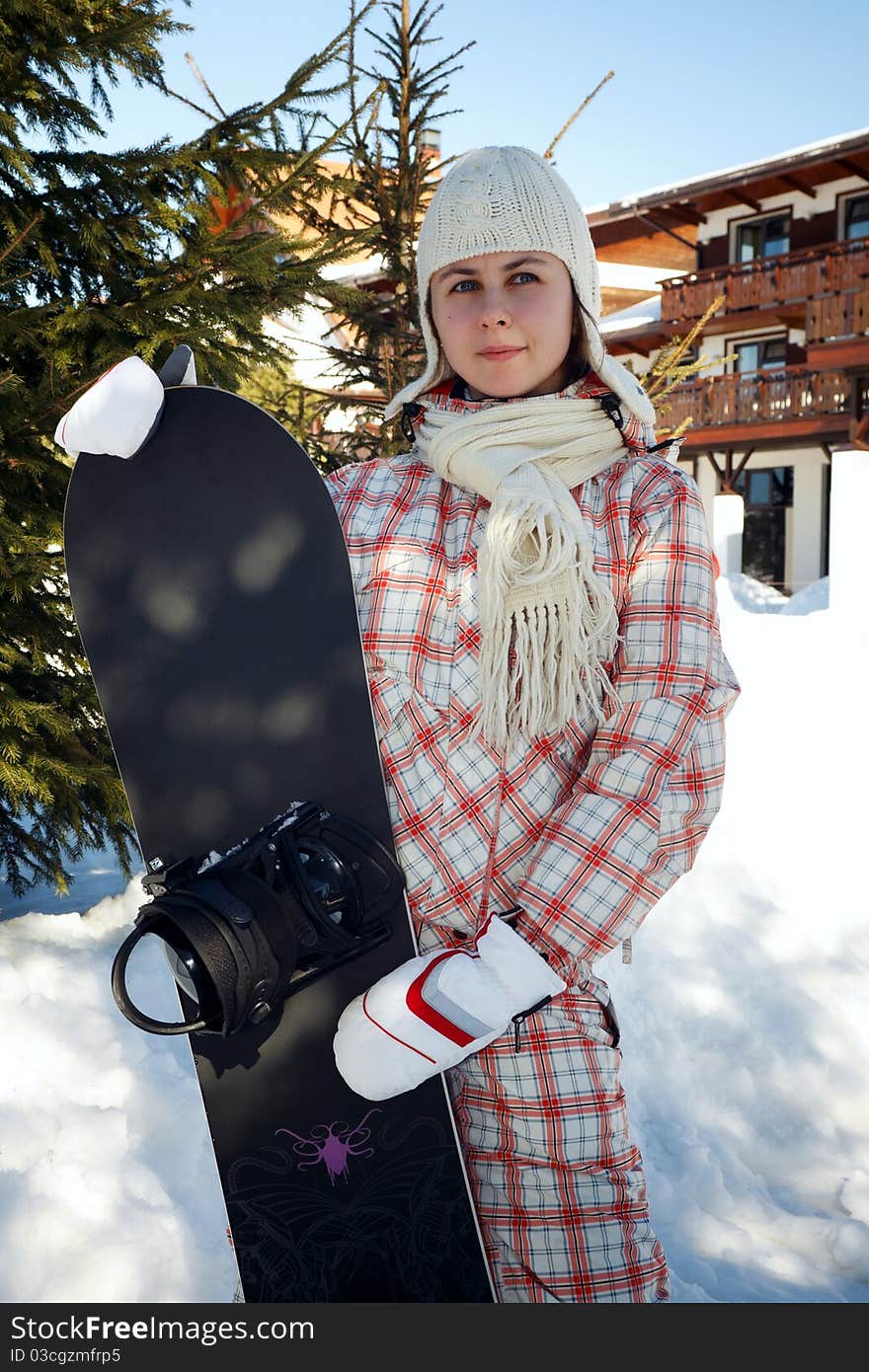 Teenage girl holding snowboard