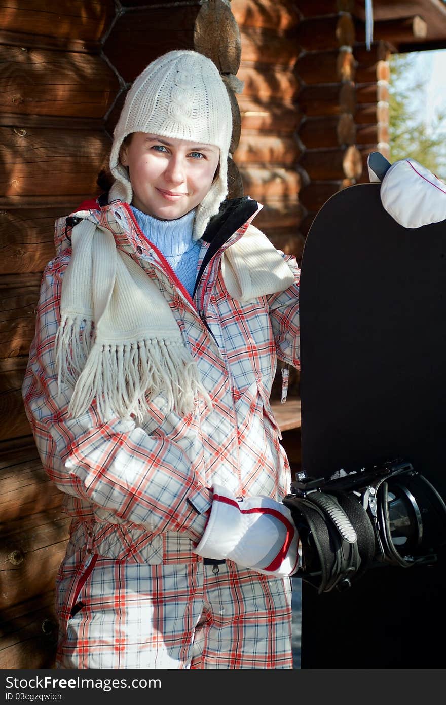 Smiling Teenage Girl Holding Snowboard