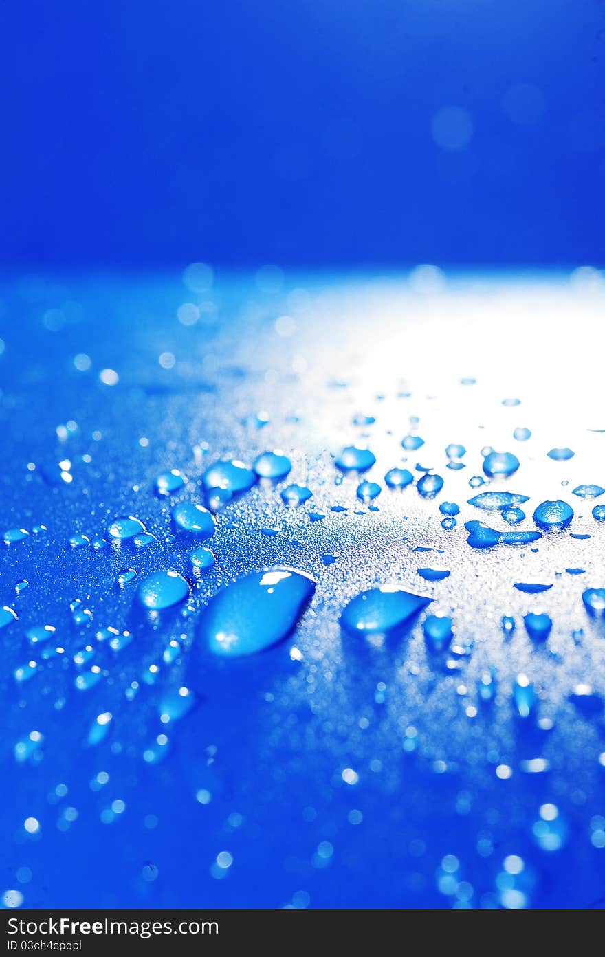 Clear water drops over blue background. texture.