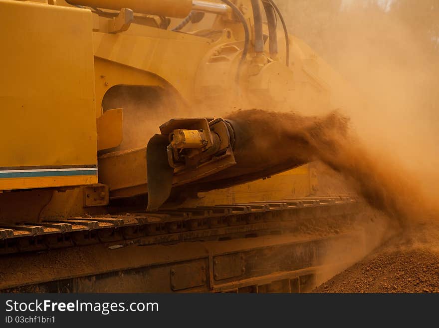 Yellow trencher machine working