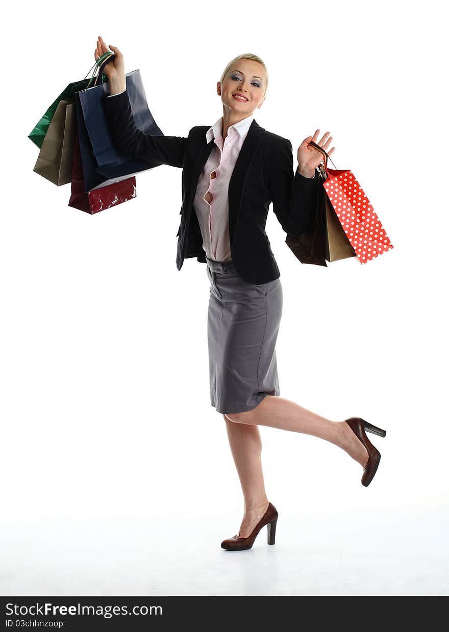 Isolated on white of young woman with short hair and make-up professionally done, holding up a shopping bags in her hands. Isolated on white of young woman with short hair and make-up professionally done, holding up a shopping bags in her hands